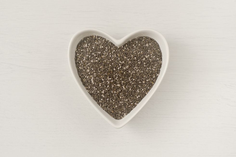 chia seeds in a heart shape plate in white background