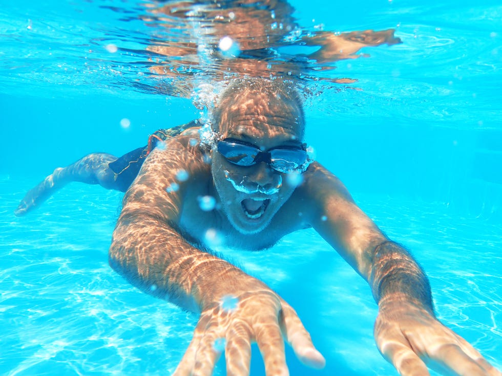 senior surfer diving into the pool at home