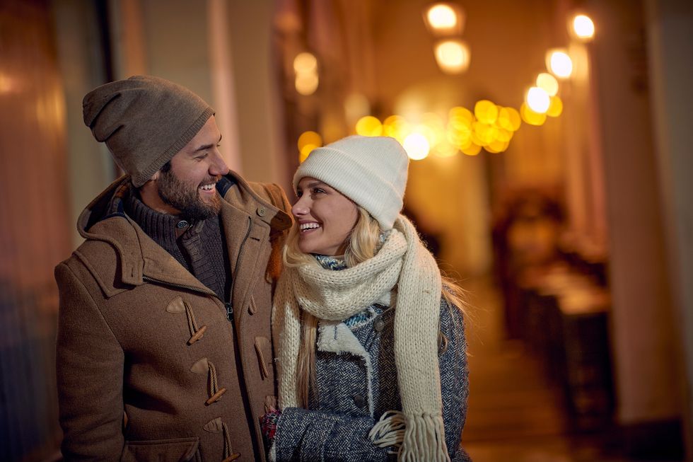 smiling couple  walking at winter night in the city