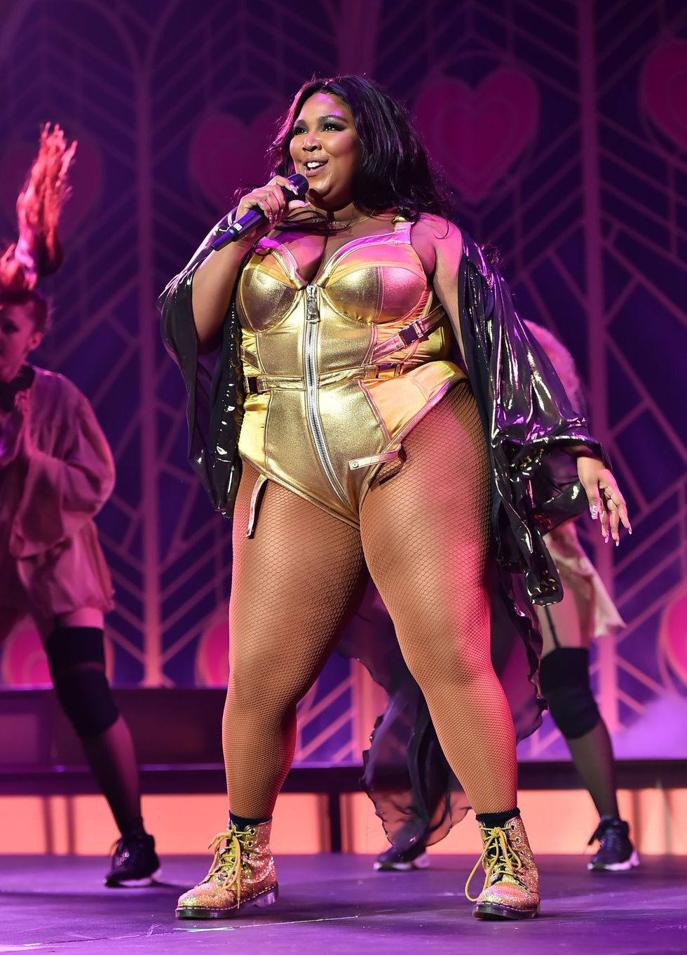 Lizzo pours into a skimpy American Football inspired mini dress as