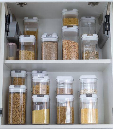 food storage containers filled with cereals in the kitchen pantry