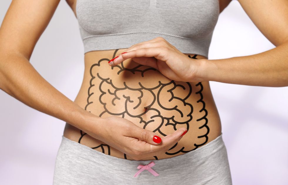 women cradling her internal organs  intestines