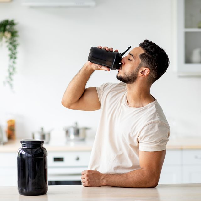 young arab guy drinking protein shake from bottle at kitchen, copy space millennial eastern man using meal replacement for weight loss, having sports supplement for muscle gain body care concept weight loss