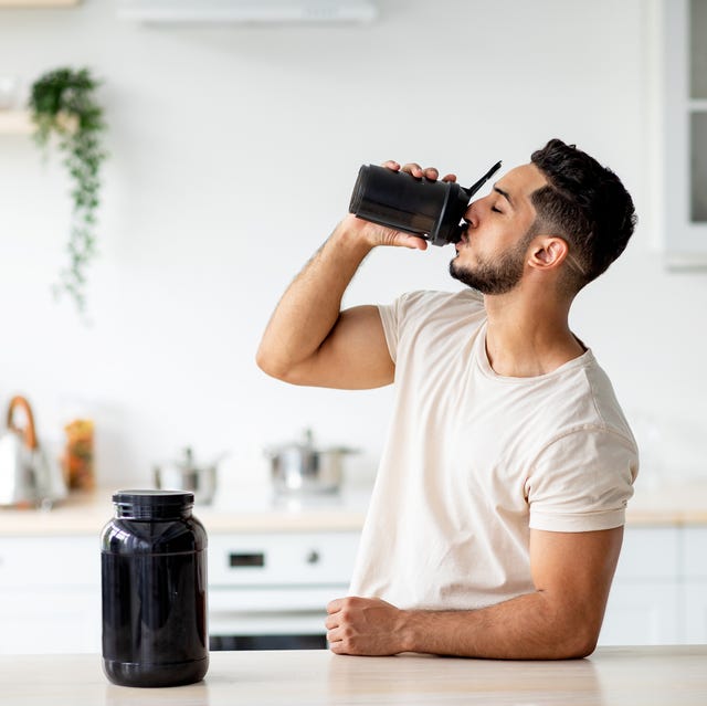 young arab guy drinking protein shake from bottle at kitchen, copy space millennial eastern man using meal replacement for weight loss, having sports supplement for muscle gain body care concept weight loss