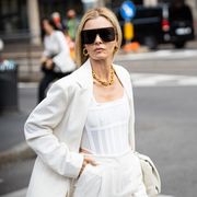 milan, italy   september 23 elizabeth sulcer, wearing a white top, white suit and white bag, poses ahead of the max mara fashion show during the milan fashion week   spring  summer 2022 on september 23, 2021 in milan, italy photo by claudio laveniagetty images