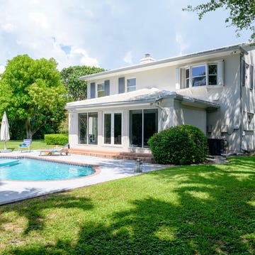 Modern two-story home in Miami with yard and swimming pool backyard view of a modern two story single family detached home with yard and swimming pool in miami, florida