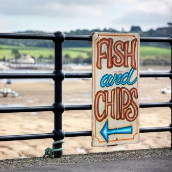 fish and chips sign at typical uk seaside resort