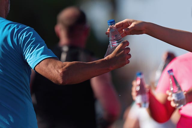 the hand of the runner grabbing the water