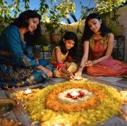 diwali wishes  family sitting and lighting diwali lights
