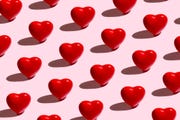 red hearts pattern on a pink background