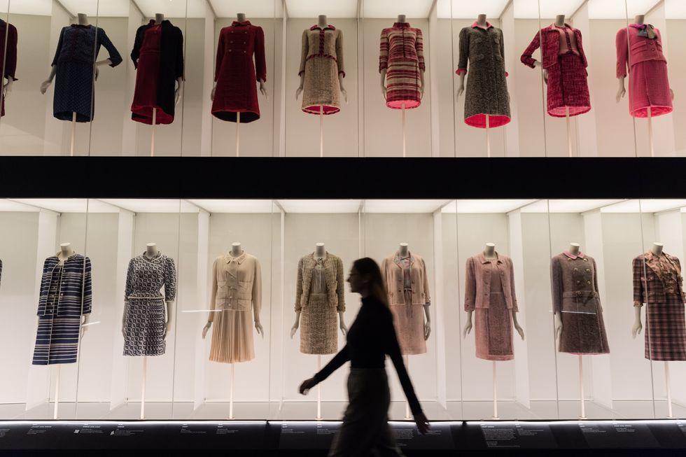 Embargoed to 00:01 Wednesday 13 September 2023] London, UK. 12 September  2023. A man views Chanel suit designs at a preview of 'Gabrielle Chanel.  Fashion Manifesto', the UK's first major exhibition of