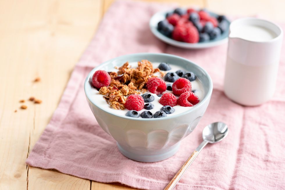 yogurt with granola and berries in bowl on wooden table healthy eating, dieting, weight loss concept