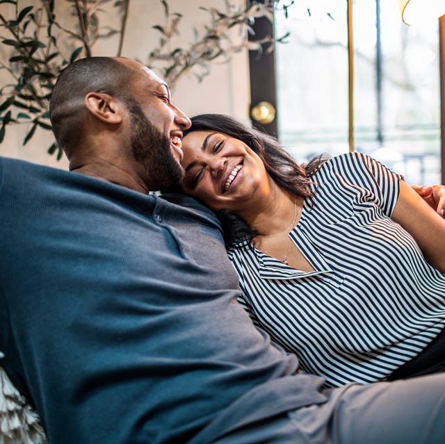 married couple embracing on sofa