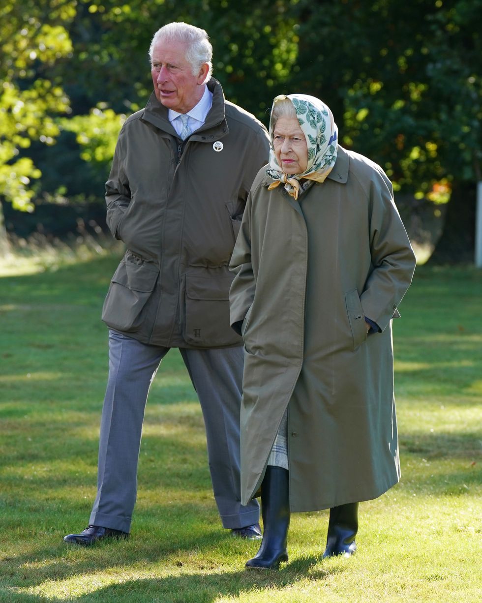 crathie,  united kingdom   october 1  queen elizabeth ii and prince charles, prince of wales known as the duke of rothesay when in scotland walk to the balmoral estate cricket pavilion to mark the start of the official planting season for the queens green canopy qgc at the balmoral estate on october 1, 2021 near crathie, scotland the qgc is a uk wide platinum jubilee initiative which will create a lasting legacy in tribute to the queens 70 years of service to the nation, through a network of trees planted in her name photo by andrew milligan wpa poolgetty images