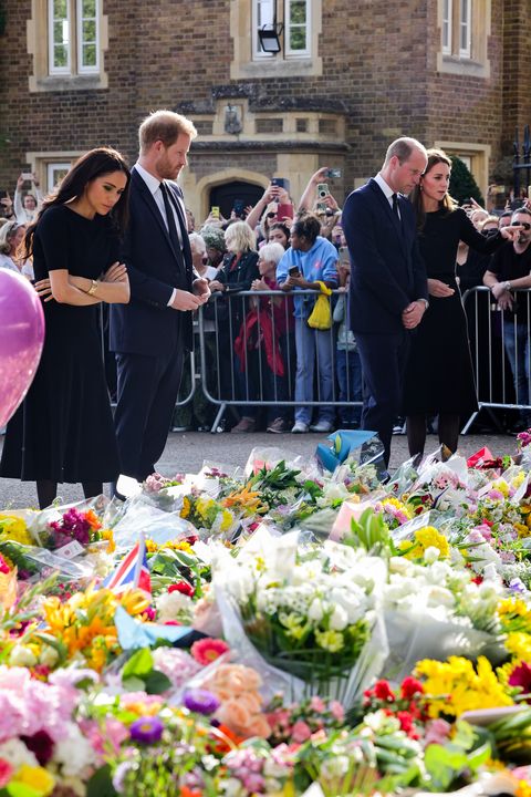 windsor, england   september 10 meghan, duchess of sussex, prince harry, duke of sussex, prince william, prince of wales and catherine, princess of wales look at floral tributes laid by members of the public on the long walk at windsor castle on september 10, 2022 in windsor, england crowds have gathered and tributes left at the gates of windsor castle to queen elizabeth ii, who died at balmoral castle on 8 september, 2022 photo by chris jackson   wpa poolgetty images