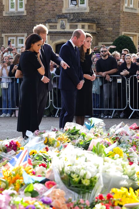windsor, england   september 10 meghan, duchess of sussex, prince harry, duke of sussex, prince william, prince of wales and catherine, princess of wales look at floral tributes laid by members of the public on the long walk at windsor castle on september 10, 2022 in windsor, england crowds have gathered and tributes left at the gates of windsor castle to queen elizabeth ii, who died at balmoral castle on 8 september, 2022 photo by chris jackson   wpa poolgetty images