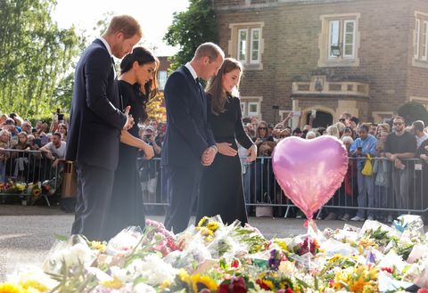 windsor, england   september 10 prince harry, duke of sussex, meghan, duchess of sussex, prince william, prince of wales and catherine, princess of wales look at floral tributes laid by members of the public on the long walk at windsor castle on september 10, 2022 in windsor, england crowds have gathered and tributes left at the gates of windsor castle to queen elizabeth ii, who died at balmoral castle on 8 september, 2022 photo by chris jackson   wpa poolgetty images