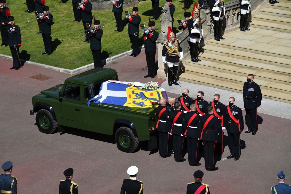 pallbearers of the royal marines stand by the coffin as it arrives at the west steps of st georges chapel during the ceremonial funeral procession of britains prince philip, duke of edinburgh in windsor castle in windsor, west of london, on april 17, 2021   philip, who was married to queen elizabeth ii for 73 years, died on april 9 aged 99 just weeks after a month long stay in hospital for treatment to a heart condition and an infection photo by justin tallis  pool  afp photo by justin tallispoolafp via getty images