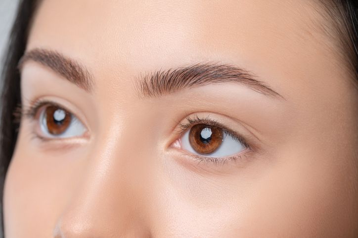 eyebrows of a young teenager girl after plucking and cutting close up the make up artist will do permanent eyebrow makeup makeup and cosmetology concept, eyebrow shape modeling