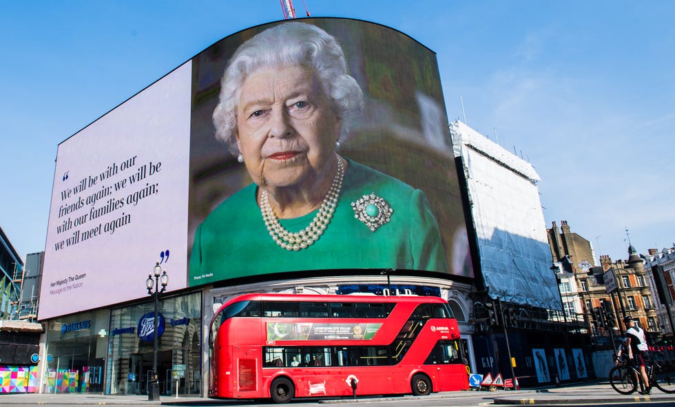 london, england april 10 an image of queen elizabeth ii and quotes from her broadcast to the nation in relation to the coronavirus epidemic are displayed on screens in piccadilly circus on april 10, 2020 in london, england photo by samir husseinwireimage