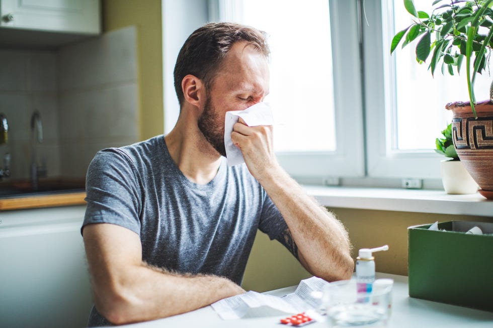 young adult man with cold , flu, running nose