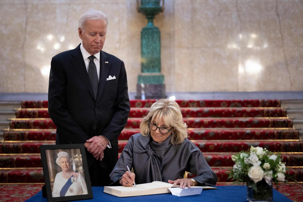 us president joe biden l looks on as us first lady jill biden signs a book of condolence at lancaster house in london on september 18, 2022, following the death of queen elizabeth ii on september 8   britain was gearing up sunday for the momentous state funeral of queen elizabeth ii as king charles iii prepared to host world leaders and as mourners queued for the final 24 hours left to view her coffin, lying in state in westminster hall at the palace of westminster photo by brendan smialowski  afp photo by brendan smialowskiafp via getty images