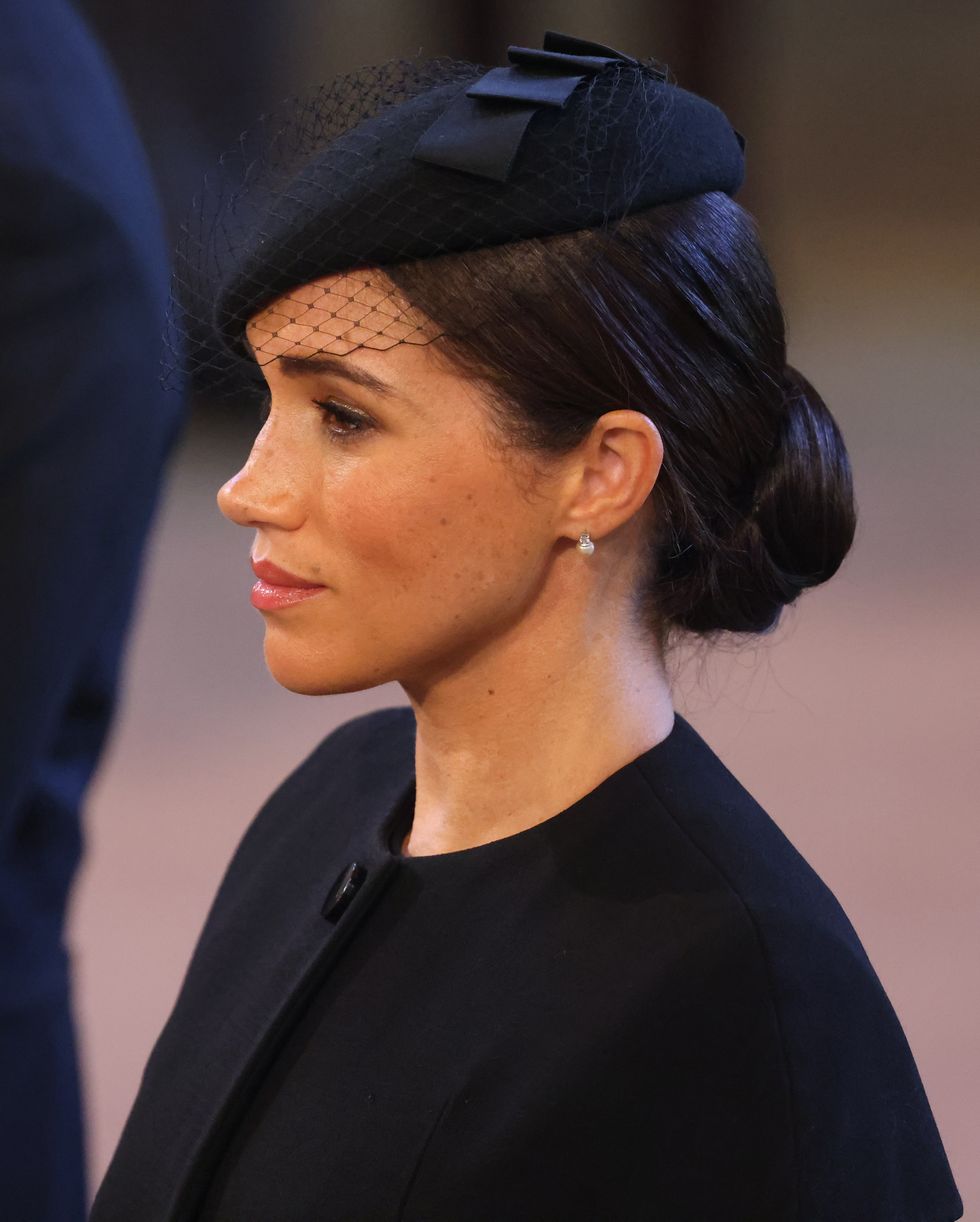 london, england   september 14   meghan, duchess of sussex looks on as the coffin of queen elizabeth ii is brought into westminster hall on september 14, 2022 in london, united kingdom queen elizabeth iis coffin is taken in procession on a gun carriage of the kings troop royal horse artillery from buckingham palace to westminster hall where she will lay in state until the early morning of her funeral queen elizabeth ii died at balmoral castle in scotland on september 8, 2022, and is succeeded by her eldest son, king charles iii photo by darren fletcher   wpa poolgetty images