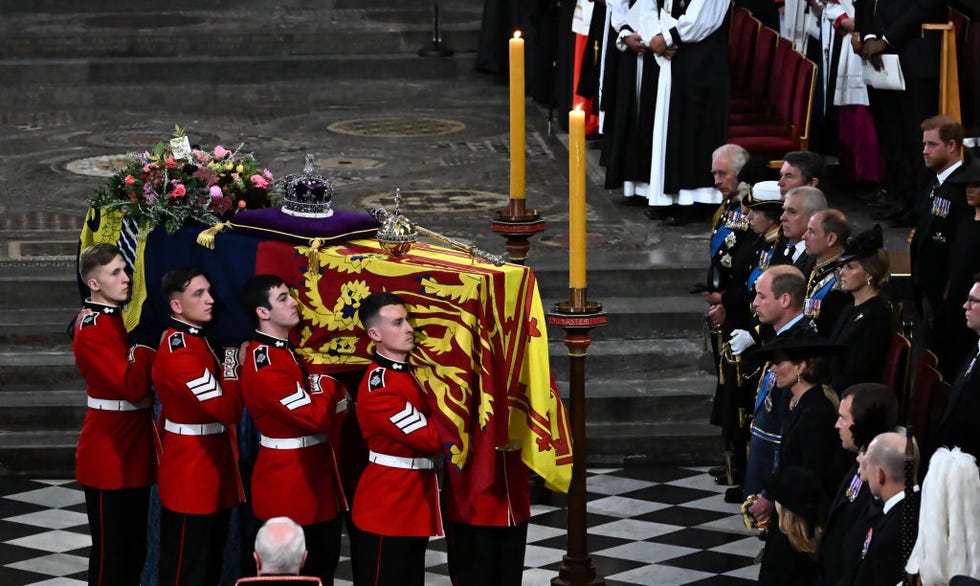 london, england   september 19 the bearer party of the queens company, 1st battalion grenadier guards carries the coffin of queen elizabeth ii, draped in a royal standard and adorned with the imperial state crown and the sovereigns orb and sceptre inside the abbey at the state funeral service for britains queen elizabeth ii, at westminster abbey on september 19, 2022 in london, england  elizabeth alexandra mary windsor was born in bruton street, mayfair, london on 21 april 1926 she married prince philip in 1947 and ascended the throne of the united kingdom and commonwealth on 6 february 1952 after the death of her father, king george vi queen elizabeth ii died at balmoral castle in scotland on september 8, 2022, and is succeeded by her eldest son, king charles iii photo by ben stansall   wpa poolgetty images