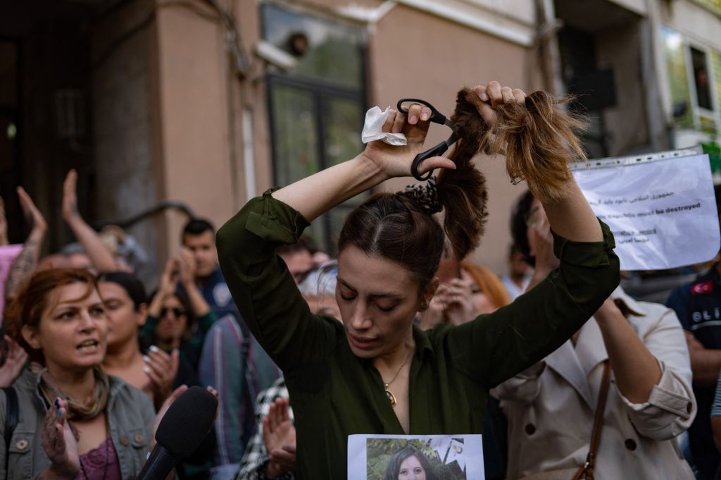nasibe samsaei, an iranian woman living in turkey, cuts her ponytail off during a protest outside the iranian consulate in istanbul on september 21, 2022, following the death of an iranian woman after her arrest by the countrys morality police in tehran   mahsa amini, 22, was on a visit with her family to the iranian capital tehran, when she was detained on september 13, 2022, by the police unit responsible for enforcing irans strict dress code for women, including the wearing of the headscarf in public she was declared dead on september 16, 2022 by state television after having spent three days in a coma photo by yasin akgul  afp photo by yasin akgulafp via getty images