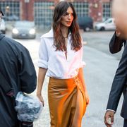 milan, italy   september 24 emily ratajkowski wears brown skirt with slit, black boots, white button shirt outside bally during the milan fashion week   womenswear springsummer 2023 on september 24, 2022 in milan, italy photo by christian vieriggetty images
