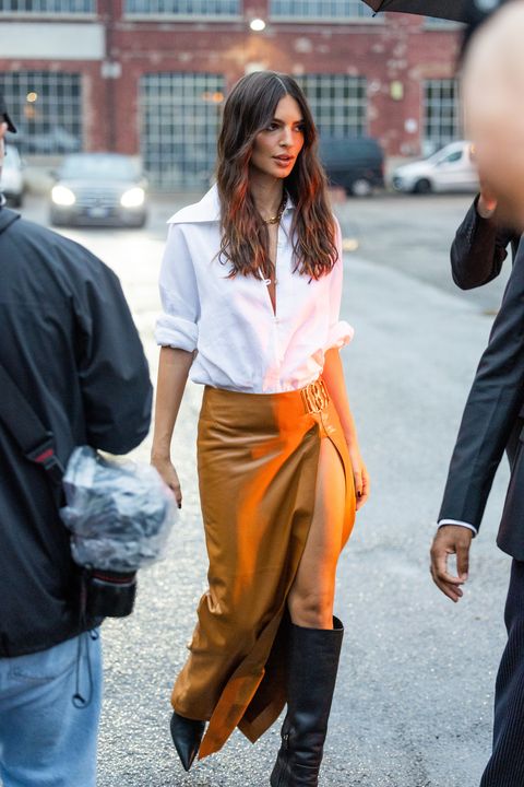 milan, italy   september 24 emily ratajkowski wears brown skirt with slit, black boots, white button shirt outside bally during the milan fashion week   womenswear springsummer 2023 on september 24, 2022 in milan, italy photo by christian vieriggetty images