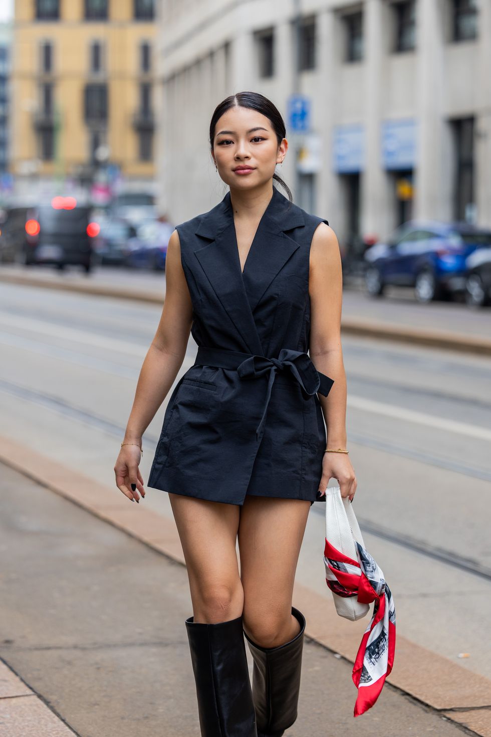 milan, italy   september 25 a guest wears black sleeveless vest, black boots outside ferrari during the milan fashion week   womenswear springsummer 2023 on september 25, 2022 in milan, italy photo by christian vieriggetty images