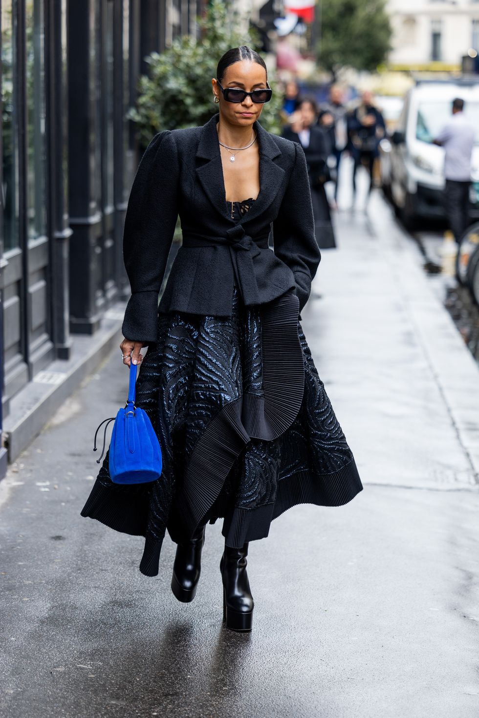 paris, france   september 28 a guest wears black tailored blazer, skirt, blue bag, boots outside rochas during paris fashion week   womenswear springsummer 2023  day three on september 28, 2022 in paris, france photo by christian vieriggetty images