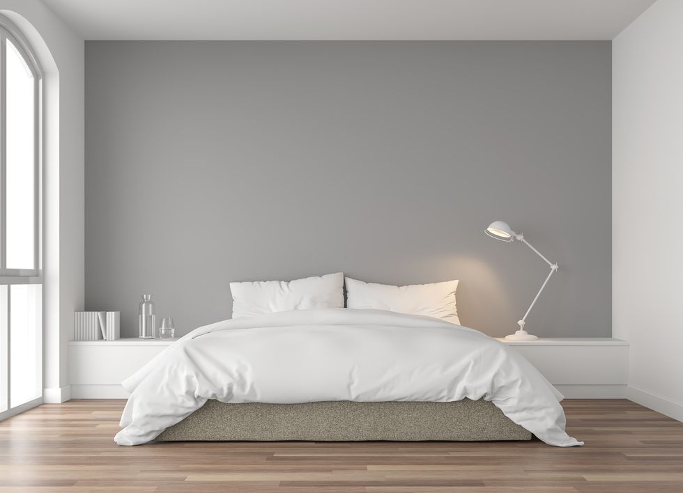 minimal bedroom 3d render,there are wood floor and  gray wallfurnished with brown fabric bed and white blanket there are arch shape window nature light shining into the room