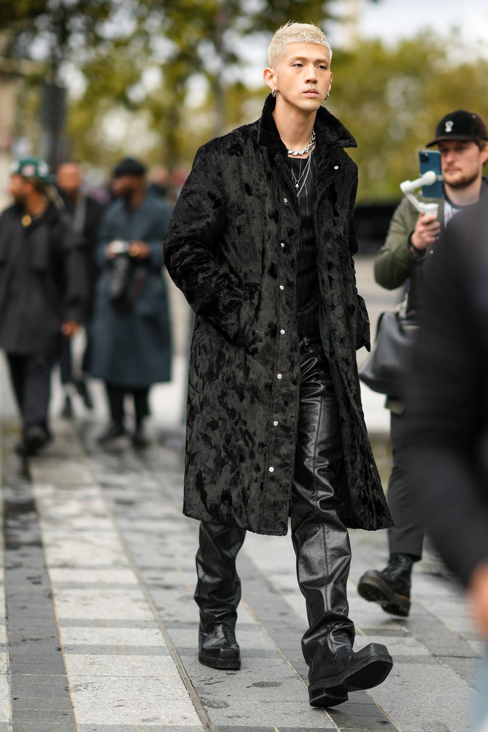paris, france   october 03 matthew kim aka bm or big matthew, wears a black shiny faux fur coat, a necklaces, a black and white striped top, black leather pants, black leather boots, outside ludovic de saint sernin, during paris fashion week   womenswear spring summer 2022, on october 03, 2021 in paris, france photo by edward berthelotgetty images