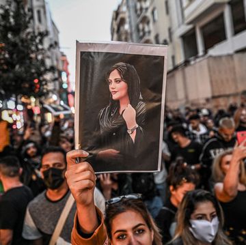 topshot   a protester holds a portrait of mahsa amini  during a demonstration in support of amini, a young iranian woman who died after being arrested in tehran by the islamic republics morality police, on istiklal avenue in istanbul on september 20, 2022   amini, 22, was on a visit with her family to the iranian capital when she was detained on september 13 by the police unit responsible for enforcing irans strict dress code for women, including the wearing of the headscarf in public she was declared dead on september 16 by state television after having spent three days in a coma photo by ozan kose  afp photo by ozan koseafp via getty images