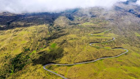 long winding road after a scenic viewing stop on their sunrise bike trek down haleakala, a nearly 10,000 foot volcano on maui haleakala national park