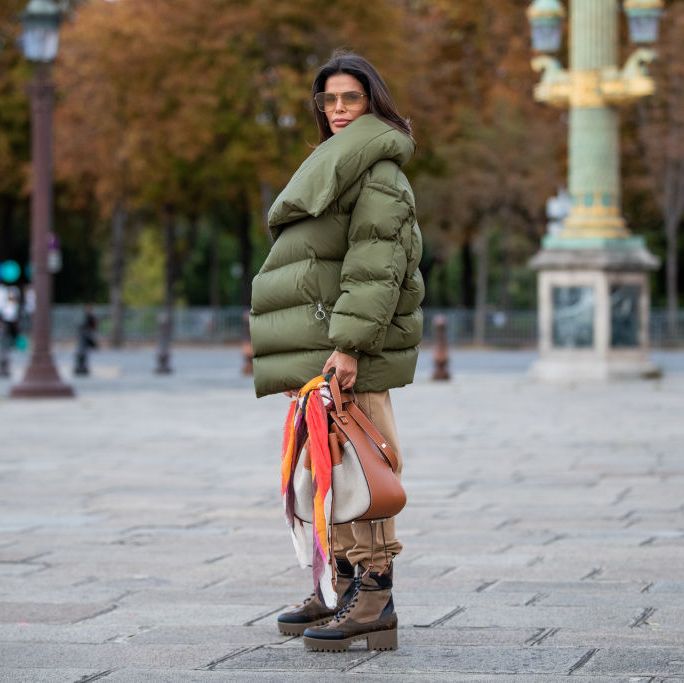paris, france   september 27 victoria barbara is seen wearing total look loewe green asymmetric down feather jacket, beige pants, louis vuitton boots during paris fashion week womenswear spring summer 2020 on september 27, 2019 in paris, france photo by christian vieriggetty images
