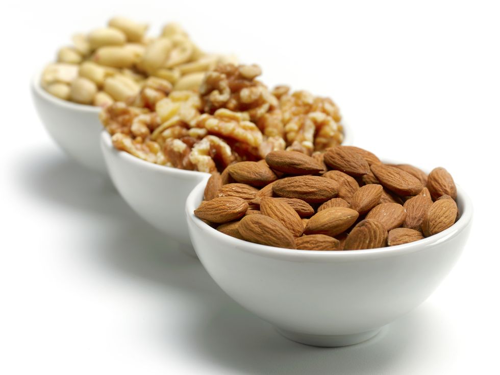 3 bowls of nuts on white background