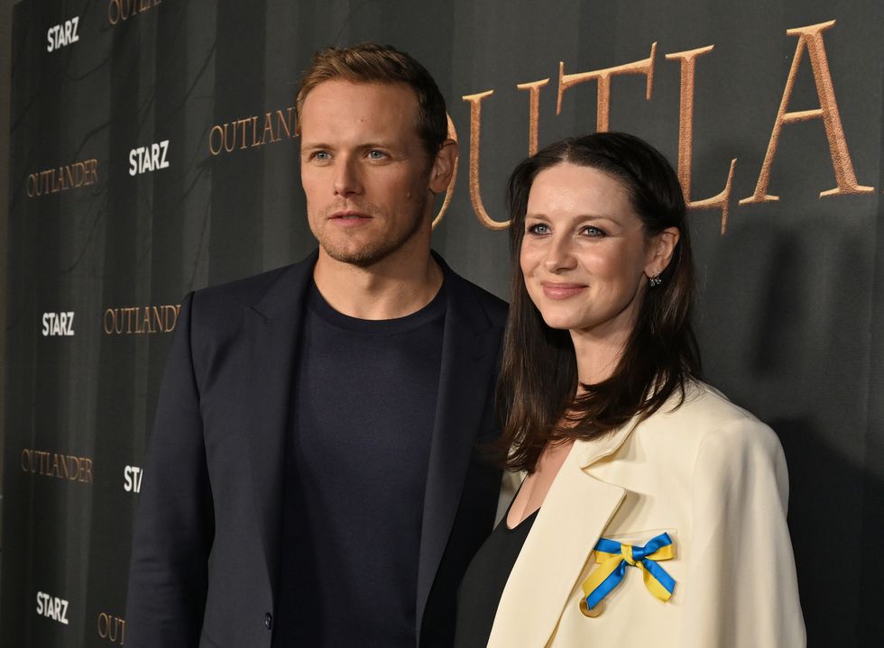 north hollywood, california   march 09 l r sam heughan and caitriona balfe attend the outlander fyc screening  panel at television academys wolf theatre at the saban media center on march 09, 2022 in north hollywood, california photo by michael kovacgetty images for starz