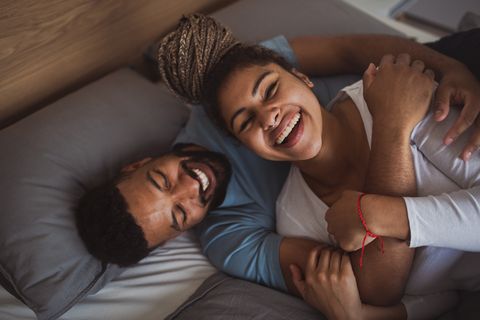 man and woman resting in bedroom, having fun
