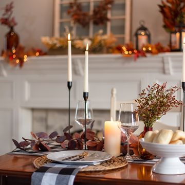 dinner table decorated for cozy fall holiday gathering