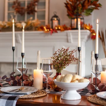 dinner table decorated for cozy fall holiday gathering