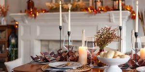 dinner table decorated for cozy fall holiday gathering