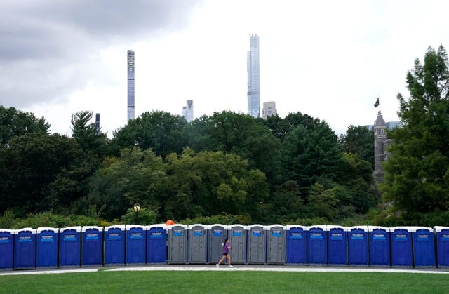 a woman runs past porta pottys on august 20, 2021, in new yorks central park, a day before thewe love nyc the homecoming concert a the culmination of nyc homecoming week, a celebration of the citys recovery during the covid 19 pandemic photo by timothy a clary  afp photo by timothy a claryafp via getty images