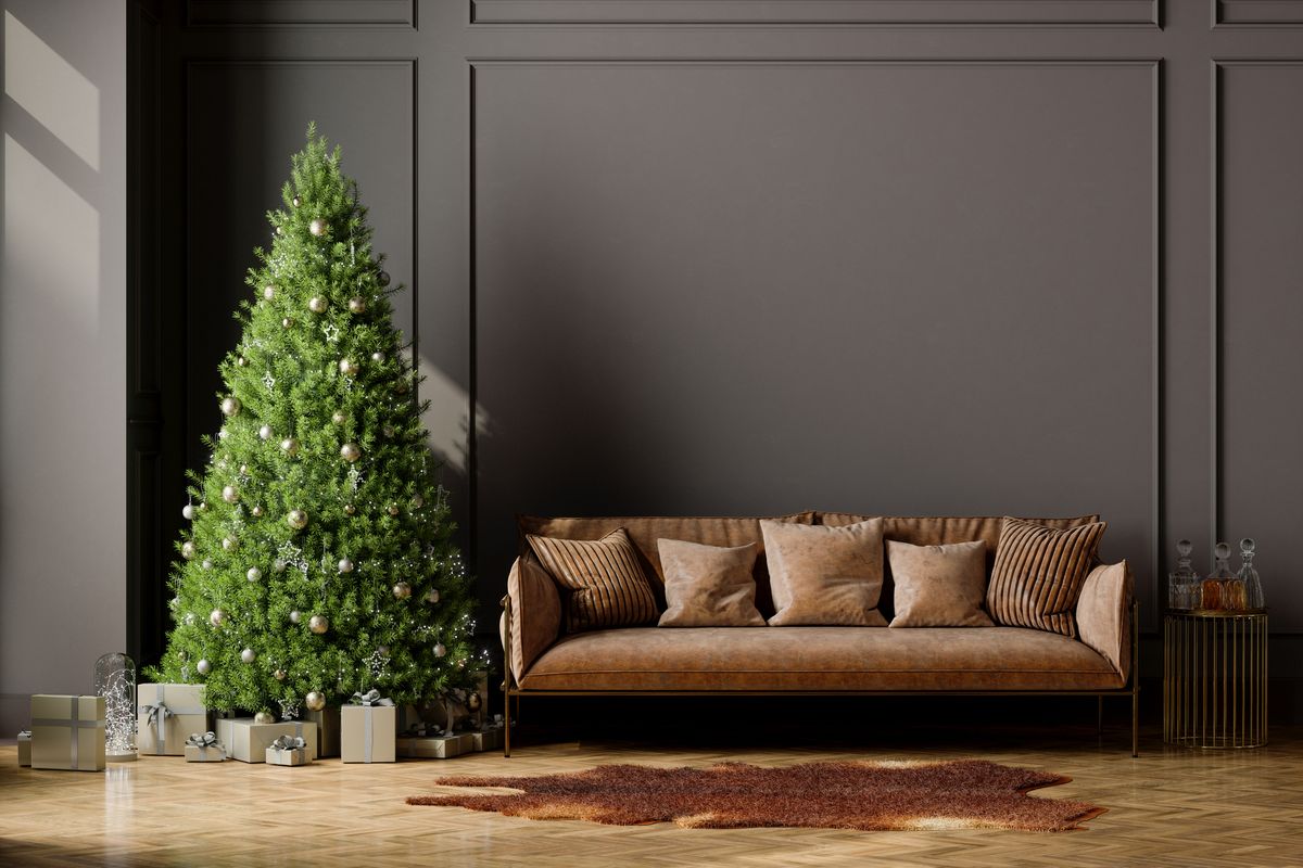 living room interior with christmas tree, gift boxes, brown leather sofa and empty wall