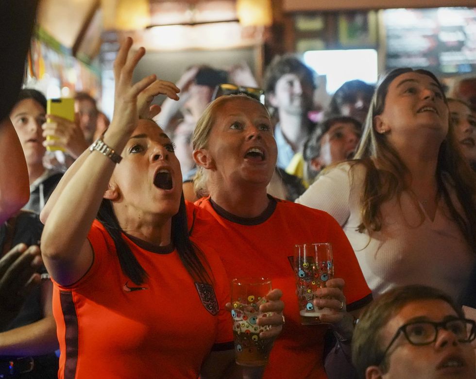 brighton, england   july 26 football fans celebrate englands third goal in the england v sweden semi final of the womens euros 2022 being played at bramall lane in sheffield, at ye olde king and queen pub on july 26, 2022 in brighton, england england takes on sweden in the semi final of the womens euros 2022 photo by chris eadesgetty images