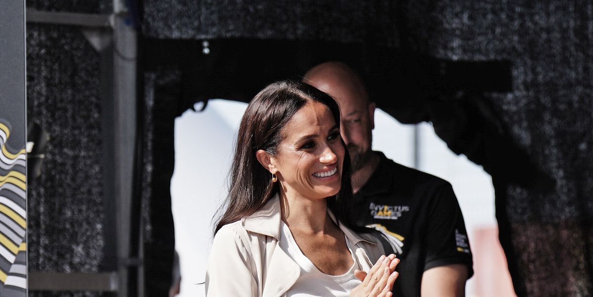 Duchess Meghan wears a soft cream coat and high-waisted trousers on Invictus Day 7