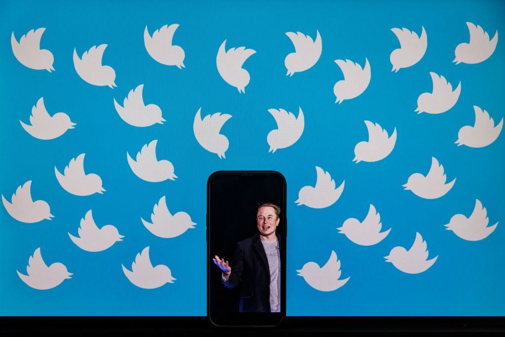 this illustration photo taken on august 5, 2022 shows a cellphone displaying a photo of elon musk placed on a computer monitor filled with twitter logos in washington, dc   elon musk has accused twitter of fraud, alleging the social media platform misled him about key aspects of its business before he agreed to a $44 billion buyout, as their court battle heats up photo by samuel corum  afp photo by samuel corumafp via getty images