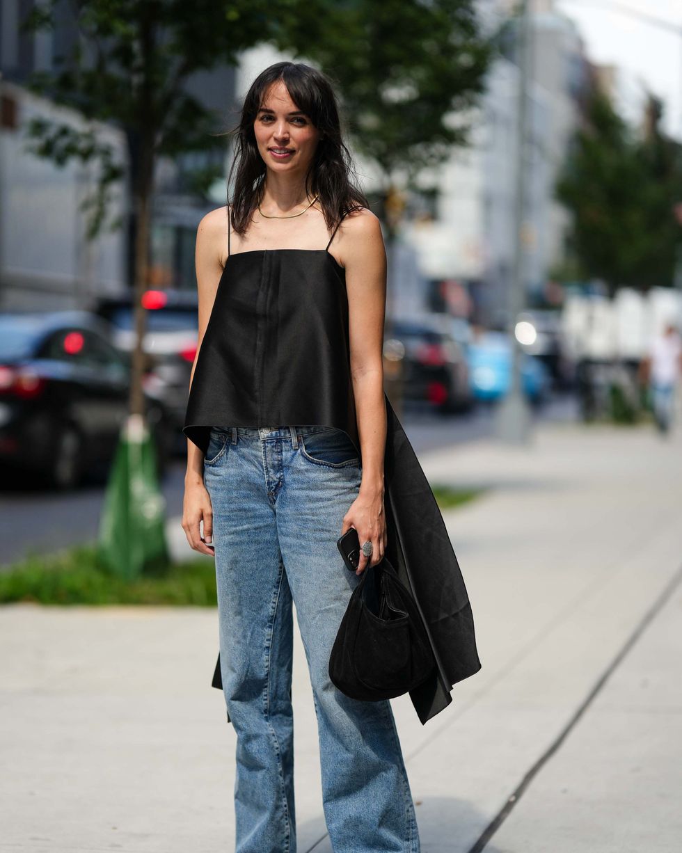 new york, new york september 09 a guest wears a balck top, blue denim pants, outside helmut lang, new york fashion week, during on september 09, 2023 in new york city photo by edward berthelotgetty images